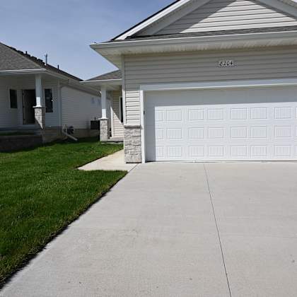a white house with a garage door that is open.
