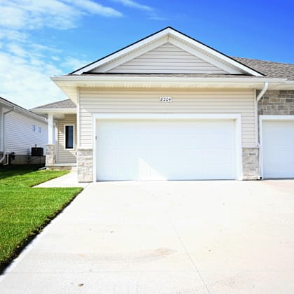 a two-car garage is attached to a house.