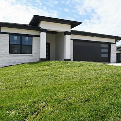 a modern house with a black garage door.