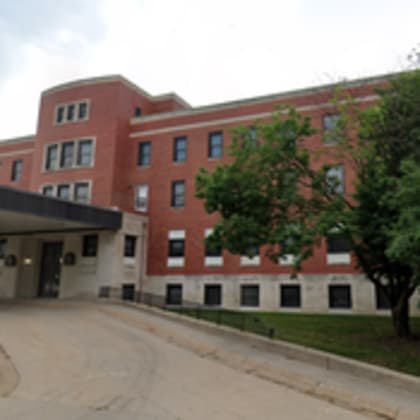 a red brick building with a covered walkway.