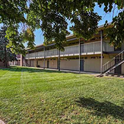 a building with a green lawn in front of it.