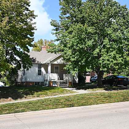 a car is parked on the street in front of a house.
