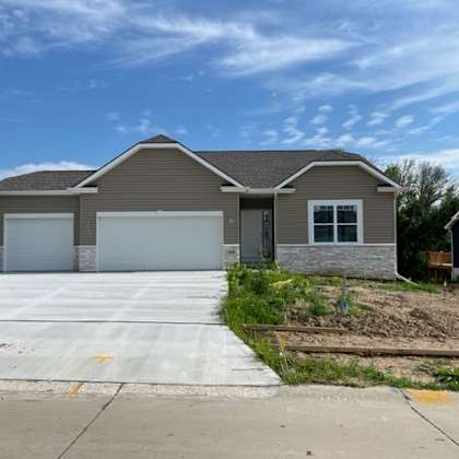 a two-story house with a garage is situated in a residential area.