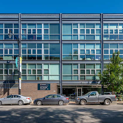 a modern building with a parking lot in front of it.