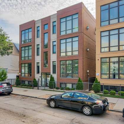 an apartment building on a city street with cars parked at montrose 3634, chicago, il