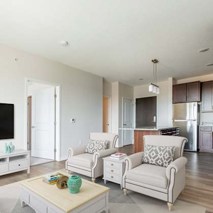a living room with white furniture and a flat screen tv at sonder point 50+ apartments, brooklyn center, 55430