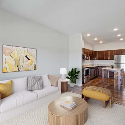 a modern living room with a white sofa and a yellow ottoman at eastgate apartments, minnesota