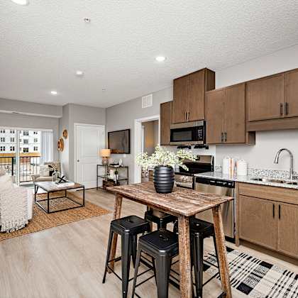open concept kitchen and living room with island at reserve at settlers ridge apartments, minnesota