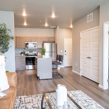 a living room and kitchen with a couch and a table at technology park apartments, rochester, minnesota