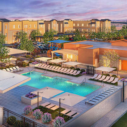 a large outdoor swimming pool surrounded by lounge chairs and umbrellas.