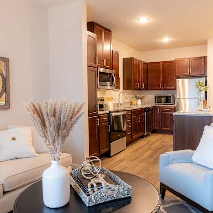 a living room and kitchen with a couch and a table