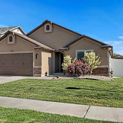 a house with a brown roof and a white garage door.