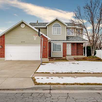 a house with a garage and a driveway in front.
