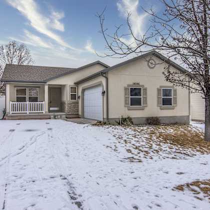 the front of a house with snow on the ground