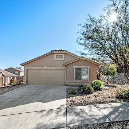 a house with a driveway and a tree in front of it