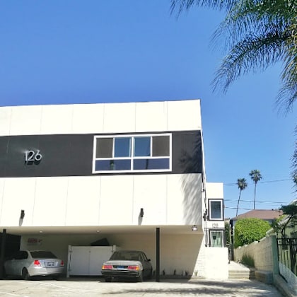 a modern house with a white facade and a black window.