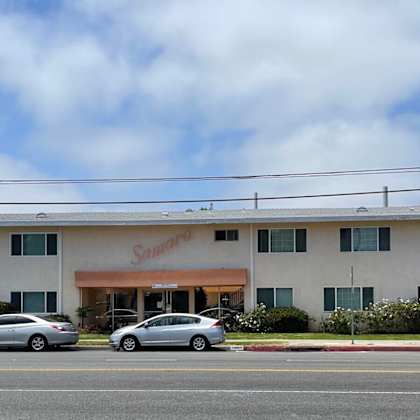 a building with two cars parked in front of it