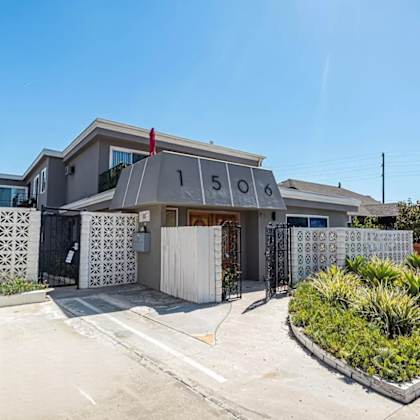 the front of a house with a driveway and a gate