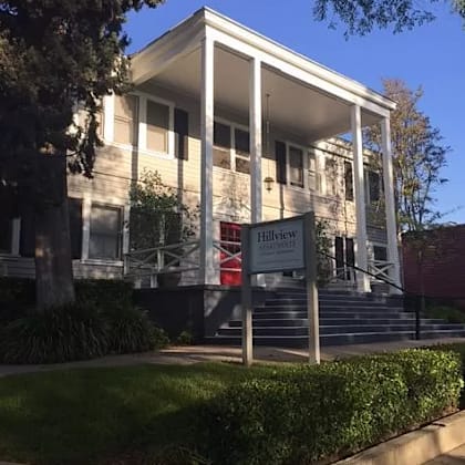 a white building with a sign in front of it