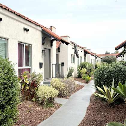 a row of houses with a pathway in the middle.
