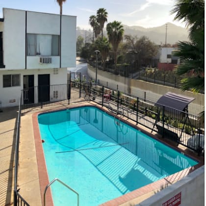 a large swimming pool in front of a building