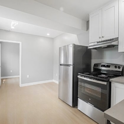 a kitchen with stainless steel appliances and white cabinets.