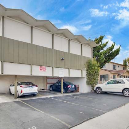 a large white building with cars parked in front of it