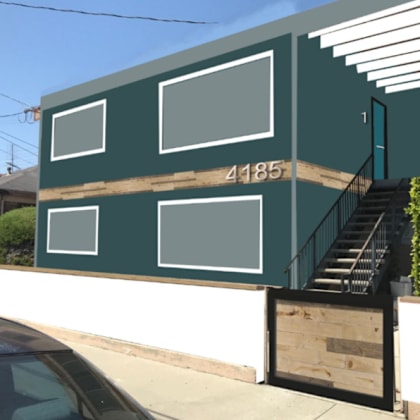 the front of a green house with a car parked in front of it