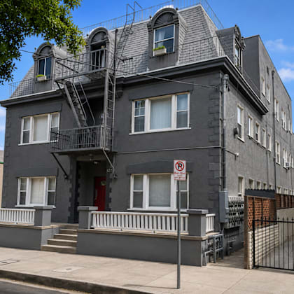 a building with a fire escape on the side of a street