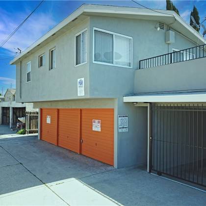 the front of a house with a garage and a gate