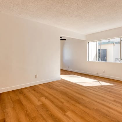 a room with wooden floors and a window.
