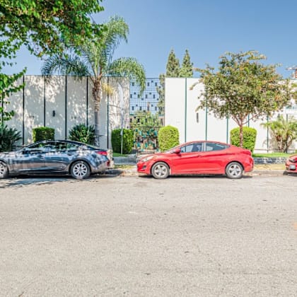 three cars parked in a parking lot.