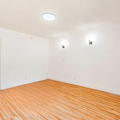 a room with wooden floors and a window.