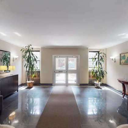 a spacious room with a large mirror on the wall.