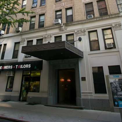 a building with a sign that says "cle iners t'ilors" on it.