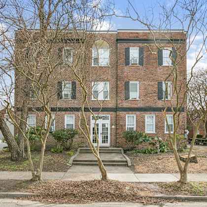 a red brick building with a white door and windows. at shipyard shores apartments, newport news, va, 23607