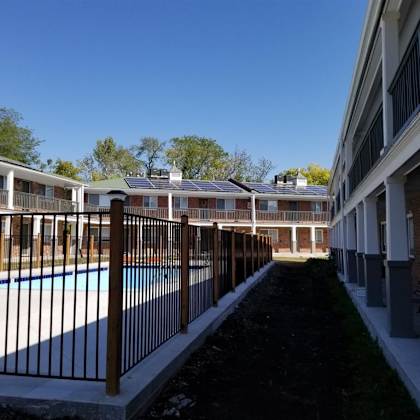 a view of a pool in a building with a fence