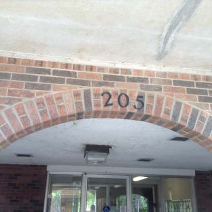 a brick archway with the number 205 painted on it.
