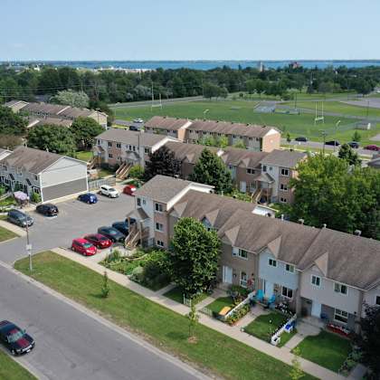 an aerial view of a neighborhood of houses with cars parked