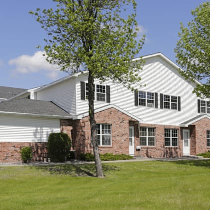 a white house with a yard and trees