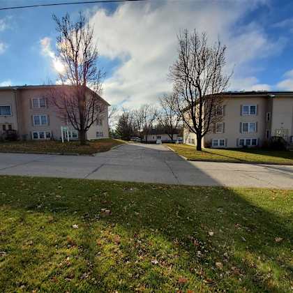 an image of an apartment building with a sidewalk