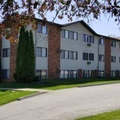 an apartment building with a street sign in front of it