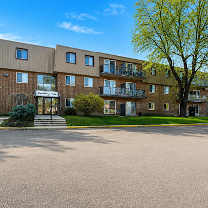 a large building with a tree in front of it.