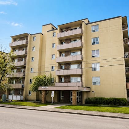 a large apartment building with balconies and multiple windows.