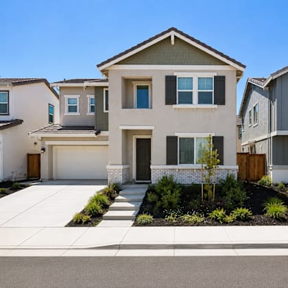 a modern two-story house with a garage and a driveway.