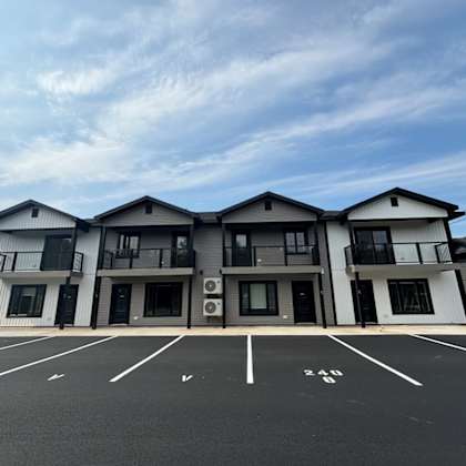 a large building with a parking lot in front of it.