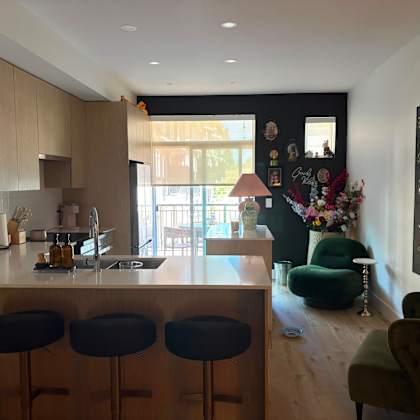 a kitchen with a bar area and a dining area.
