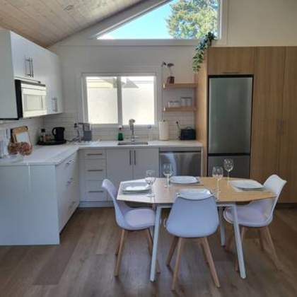 a kitchen with a table and chairs in front of it.