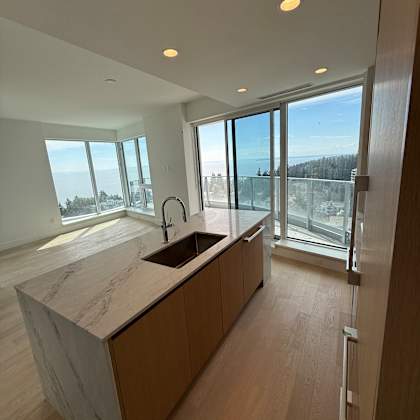 a view from the top of a building looking down at a wooden staircase.