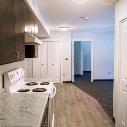 a kitchen with a stove top oven and a refrigerator.